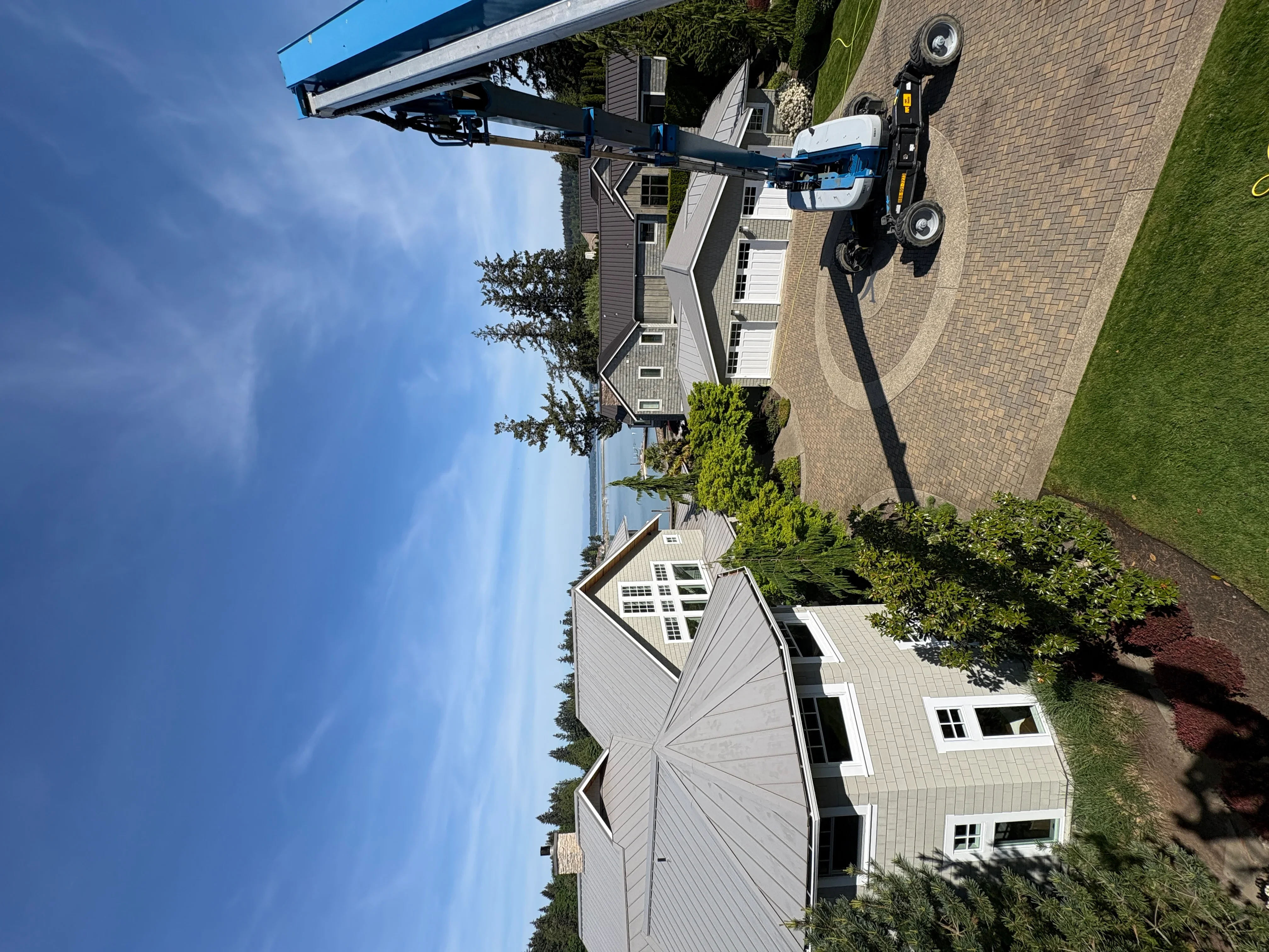 Pressure-washed brick paver driveway and patio with equipment on site