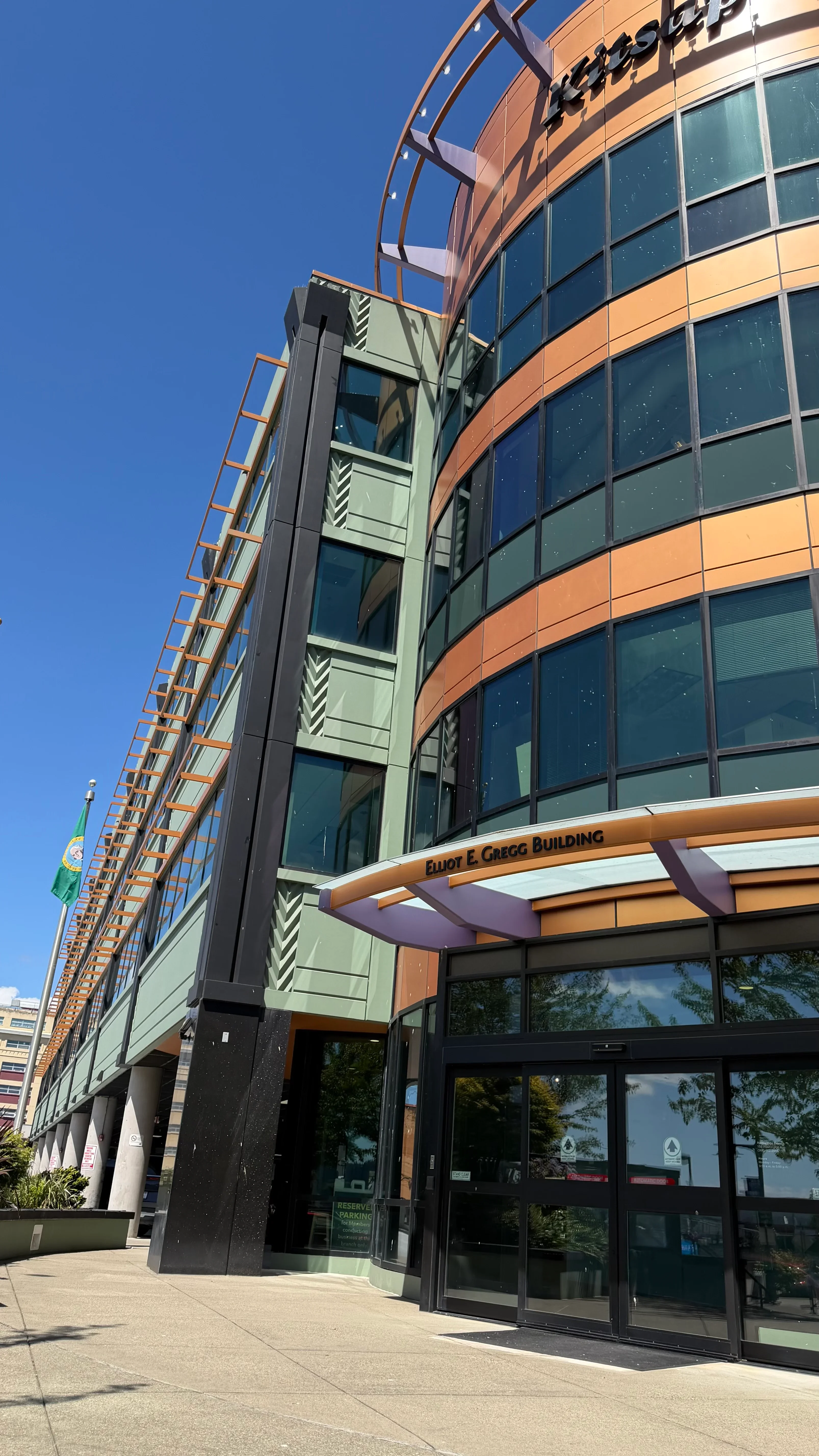Multi-story commercial building with cleaned glass curtain wall, terra cotta panels, and black trim