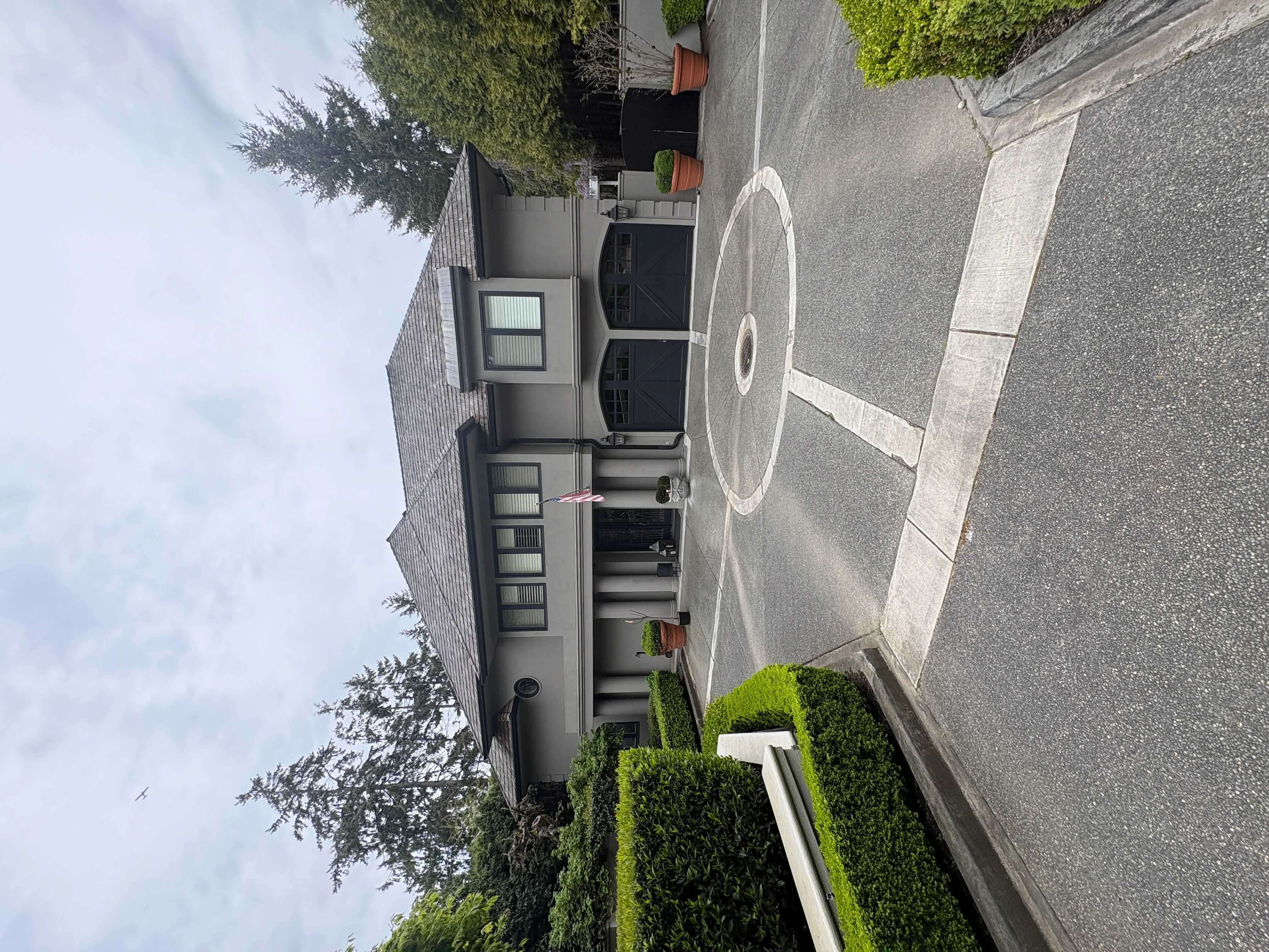 Pressure-washed asphalt driveway and concrete surfaces with clean lines and restored appearance